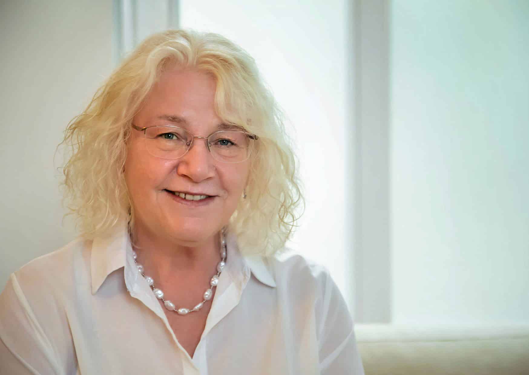 Portrait of an experienced female hypnotherapist offering trusted and personal support.